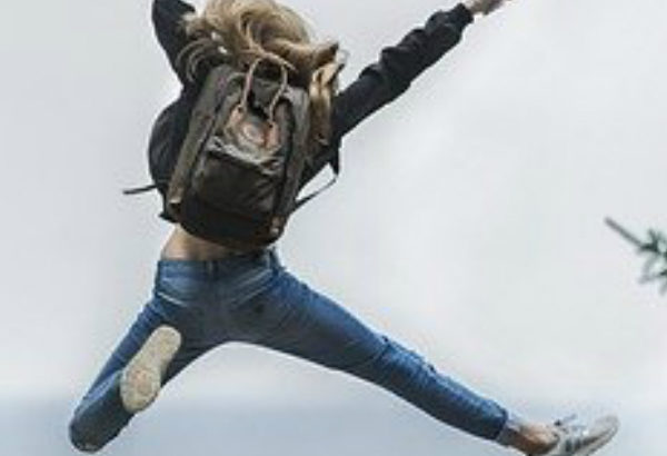 girl jumping with joy as she knows how to be happy