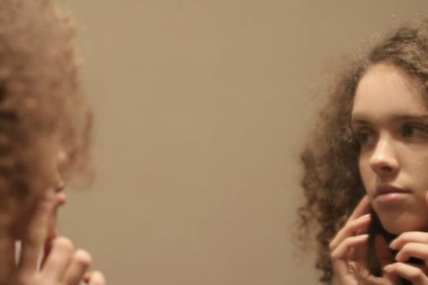 teenager examining why acne is common